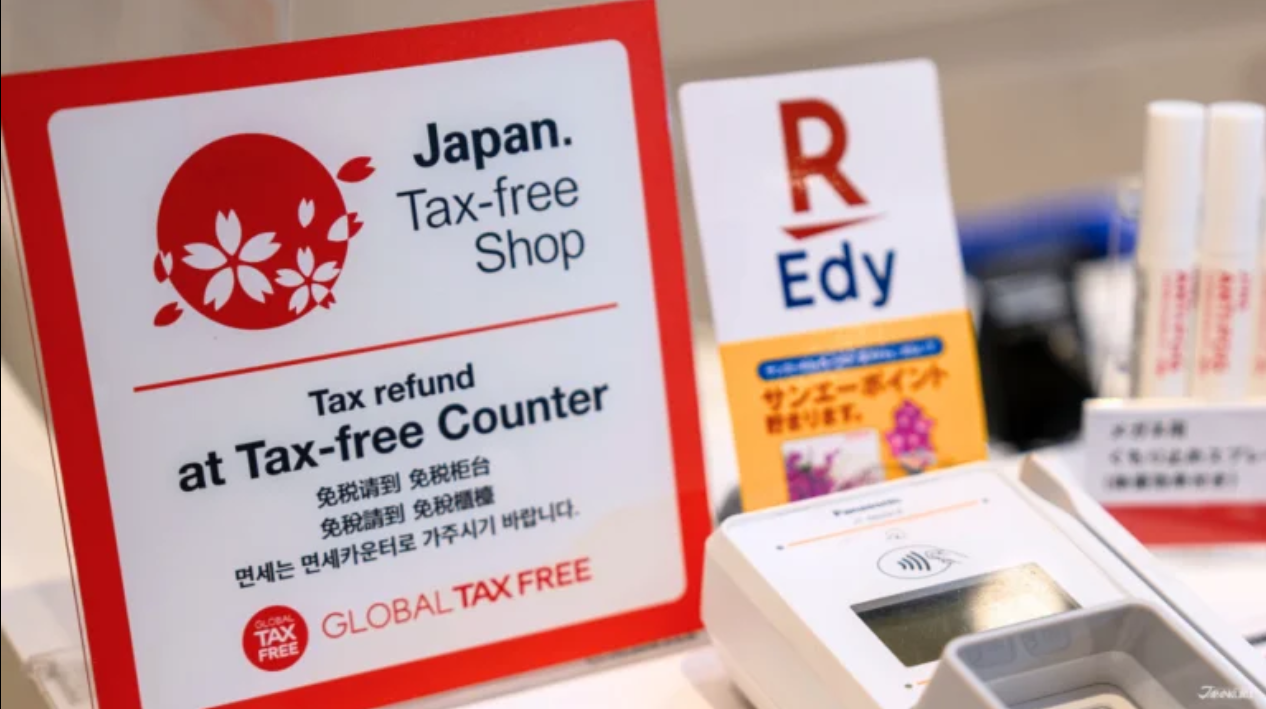 Red and white Japan Tax-free Shop sign displayed at a shop counter